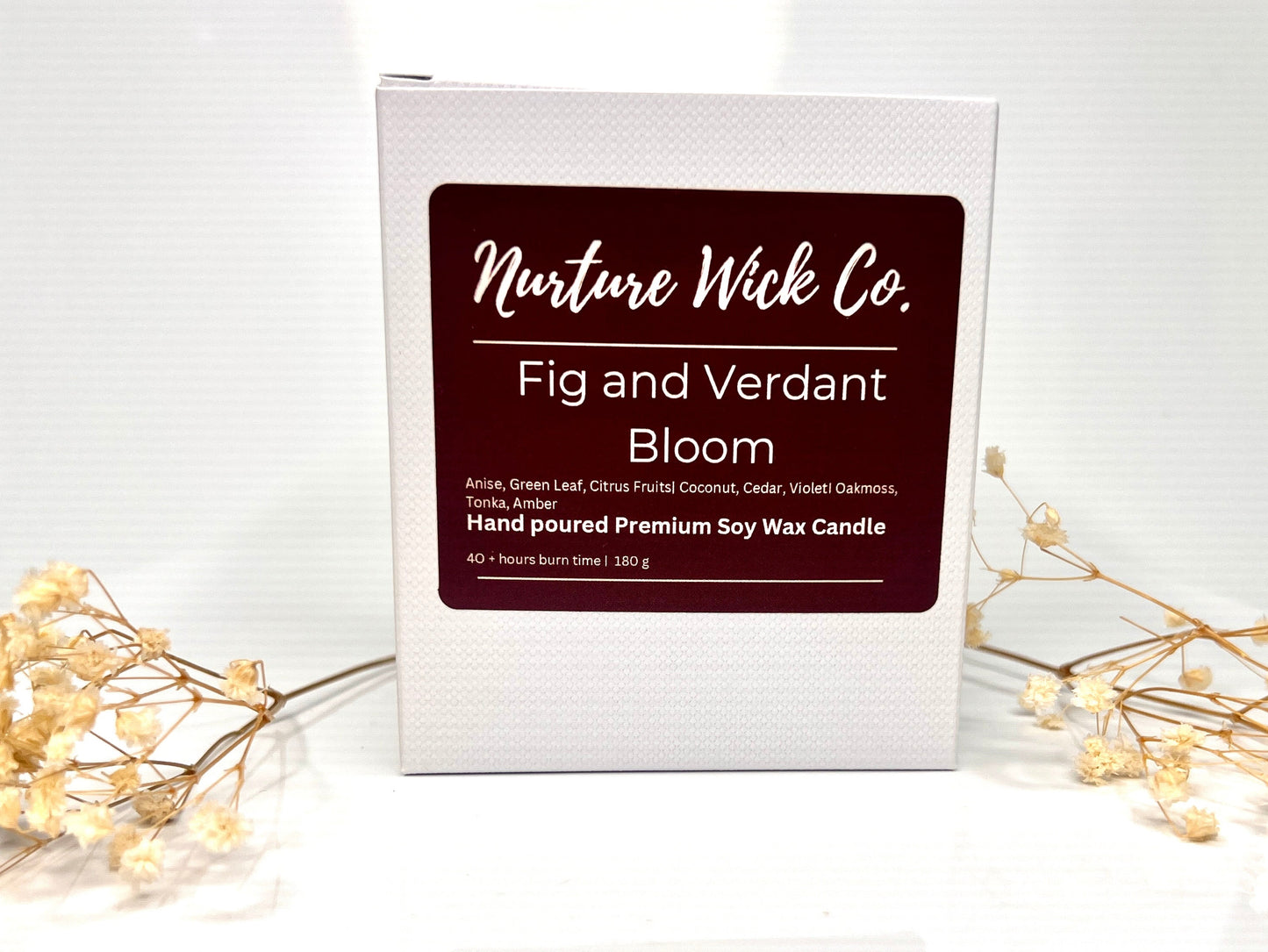 Candle packaging with 'Nurture Wick Co' label on a white surface with decorative elements.