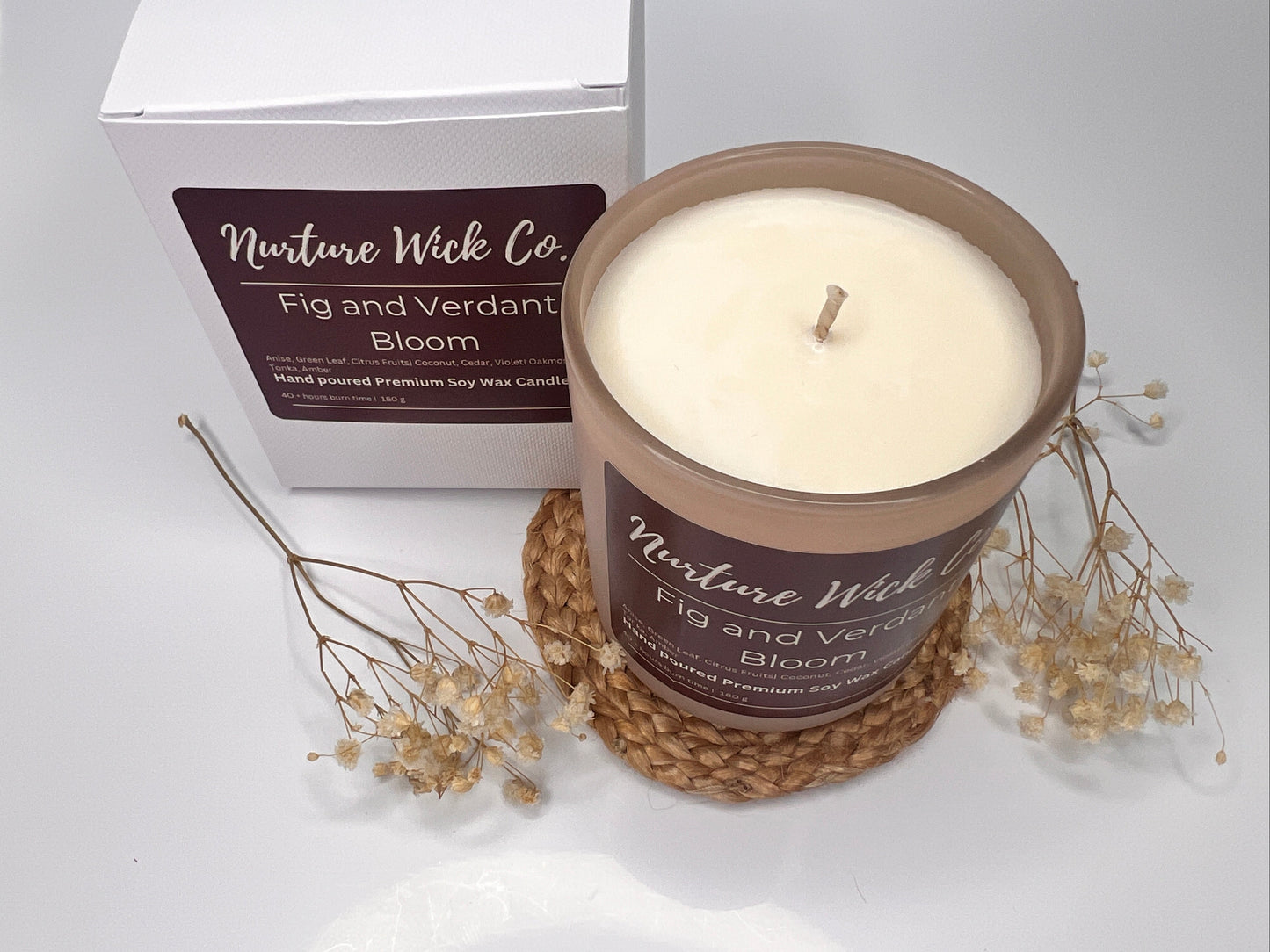 Candle with 'Nurture Wick Co.' label on a white background