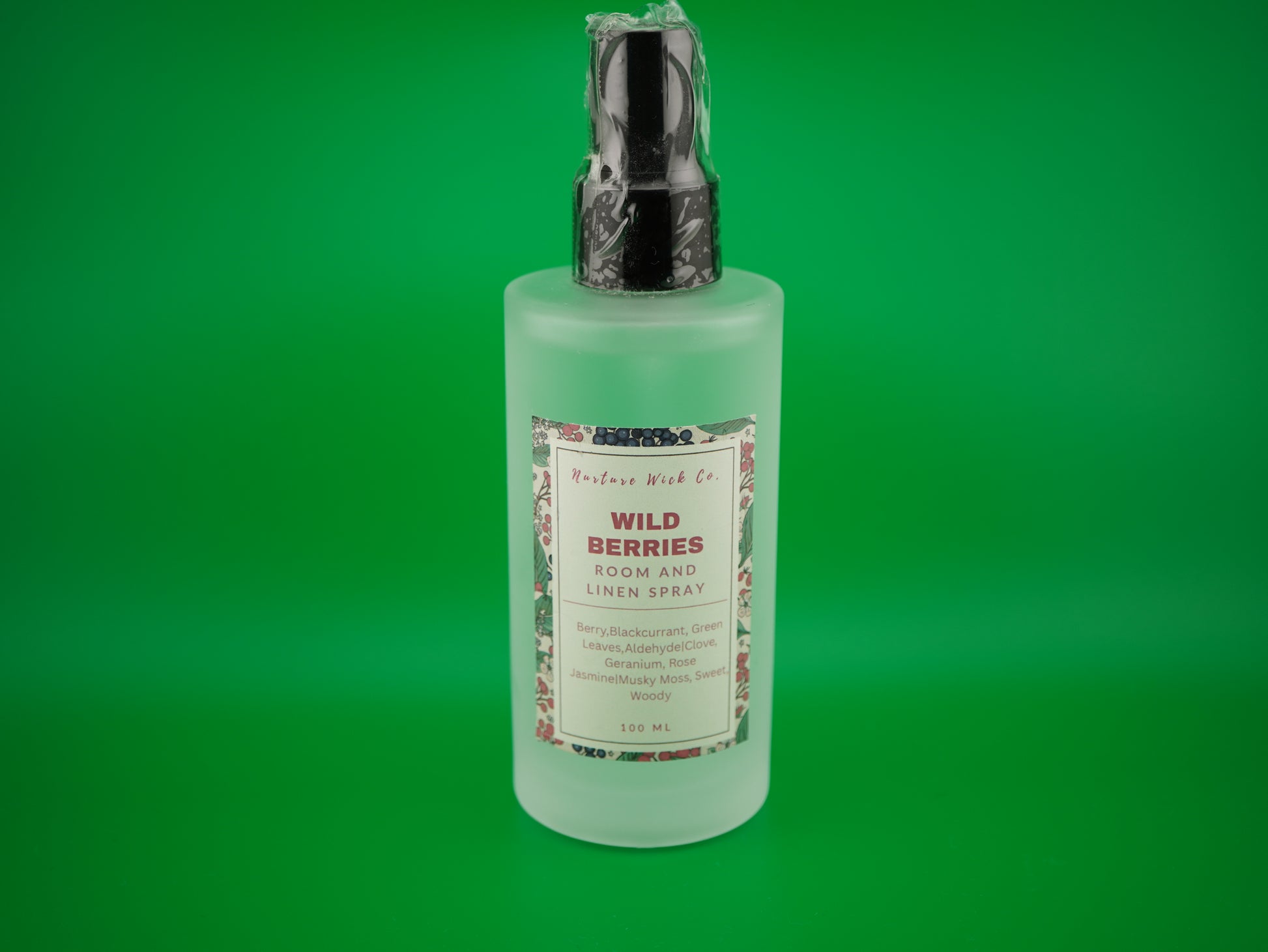 Room spray bottle with label on a green background